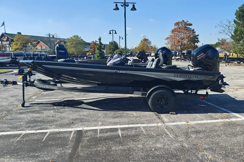 The Image of 2027 Ranger RT188 boat in parking lot, black exterior, on trailer, outdoor setting. - 0