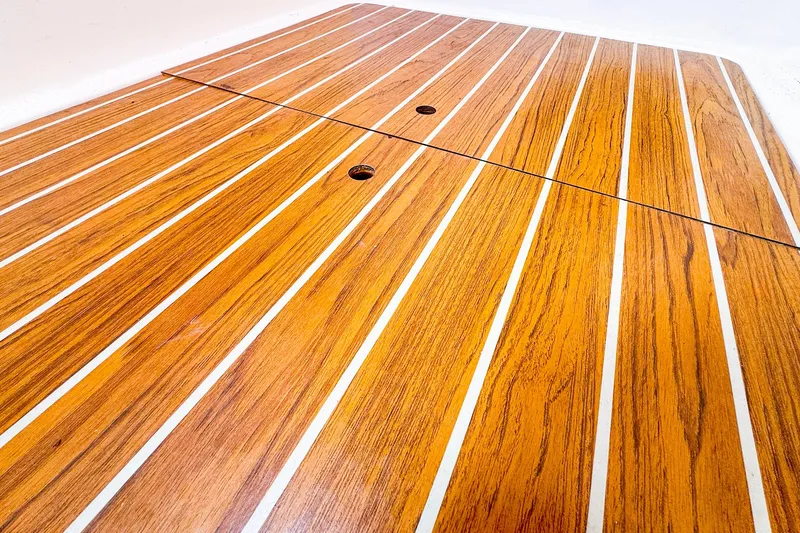 Slide: The Image of Teak deck of 2005 J Boats J/100 sailboat, featuring sleek wooden finish. - 25