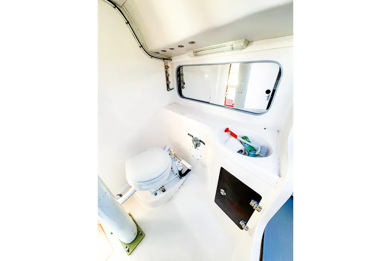 Slide: The Image of Compact bathroom interior of 2005 J Boats J/100 sailboat, featuring toilet and storage. - 16
