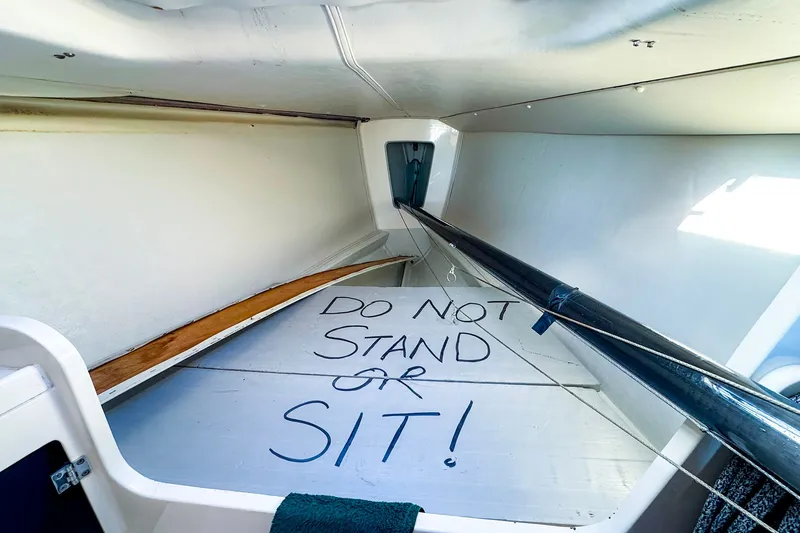 Slide: The Image of Interior of 2005 J Boats J/100 with "Do Not Stand or Sit" warning sign. - 15