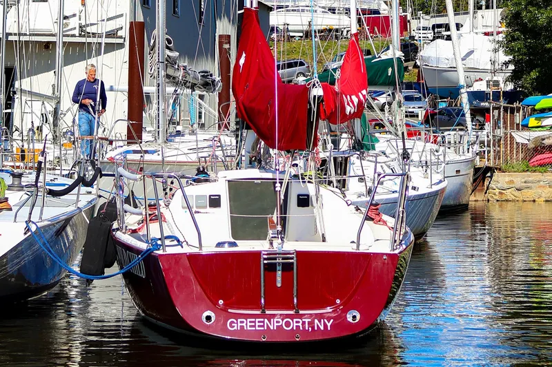 Slide: The Image of Red 2005 J Boats J/100 sailboat docked in Greenport, NY marina. - 2