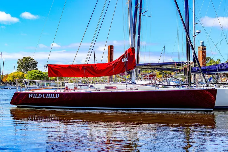 The Image of 2005 J Boats J/100 sailboat "Wild Child" docked with red sail cover. - 0