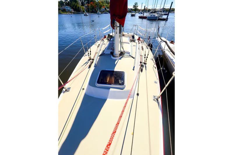 Slide: The Image of 2005 J Boats J/100 sailboat deck view, docked in a serene marina setting. - 4