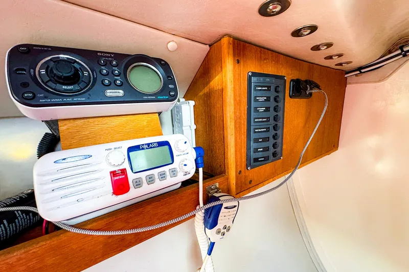 Slide: The Image of Control panel and radio equipment inside a 2005 J Boats J/100 sailboat cabin. - 14
