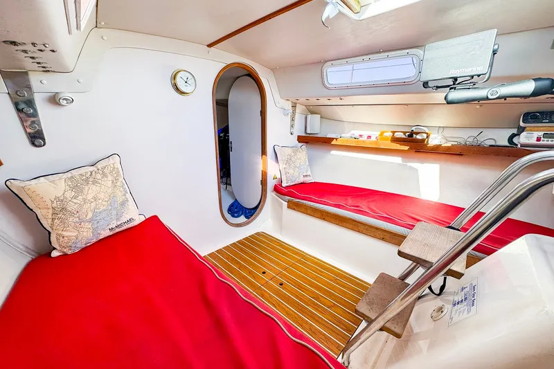 Slide: The Image of Interior of 2005 J Boats J/100 sailboat with red cushions and nautical decor. - 27