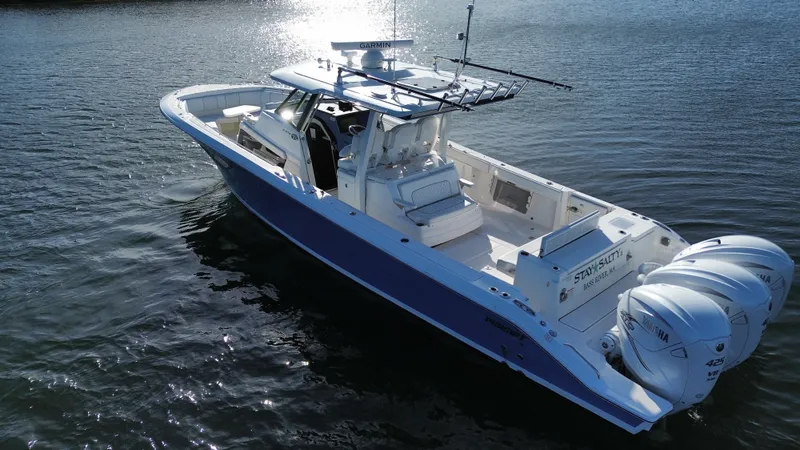 Slide: The Image of A 2021 Pursuit S 378 Sport boat on calm water with three outboard engines. - 19
