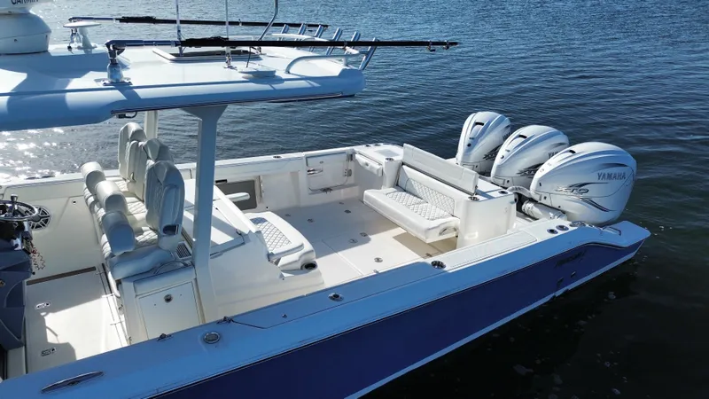Slide: The Image of The image shows a 2021 Pursuit S 378 Sport boat with three Yamaha engines on calm water. - 14