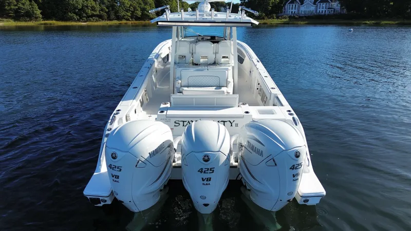 Slide: The Image of 2021 Pursuit S 378 Sport with three Yamaha 425 HP outboard engines on calm water. - 17