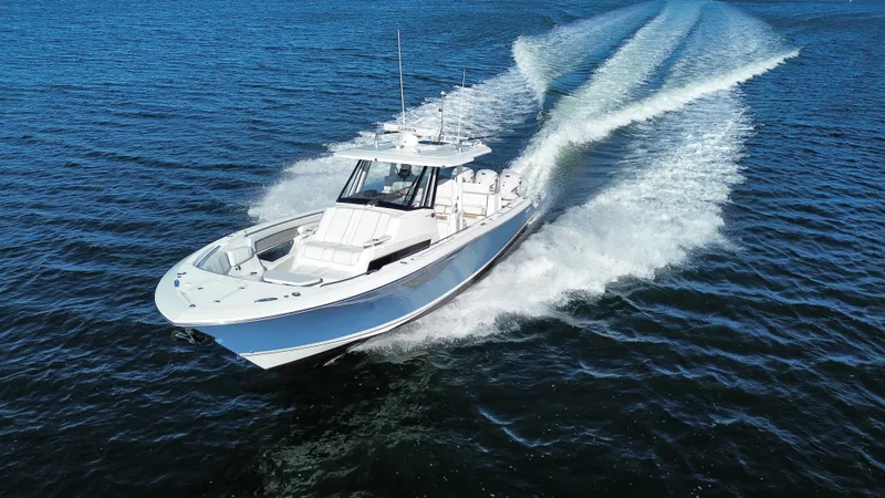 Slide: The Image of A 2021 Pursuit S 378 Sport glides swiftly over the water, leaving a trail of spray. - 23