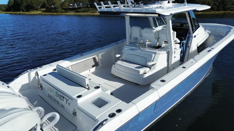 Slide: The Image of A 2021 Pursuit S 378 Sport on calm water. Spacious deck with seating. - 16