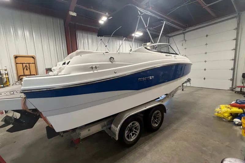The Image of 2018 Rinker MTX 22 CC boat on trailer in a garage setting. - 0