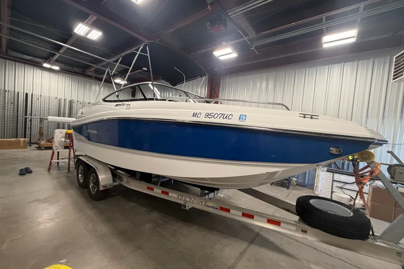 Slide: The Image of 2018 Rinker MTX 22 CC boat on trailer in indoor storage facility. - 5