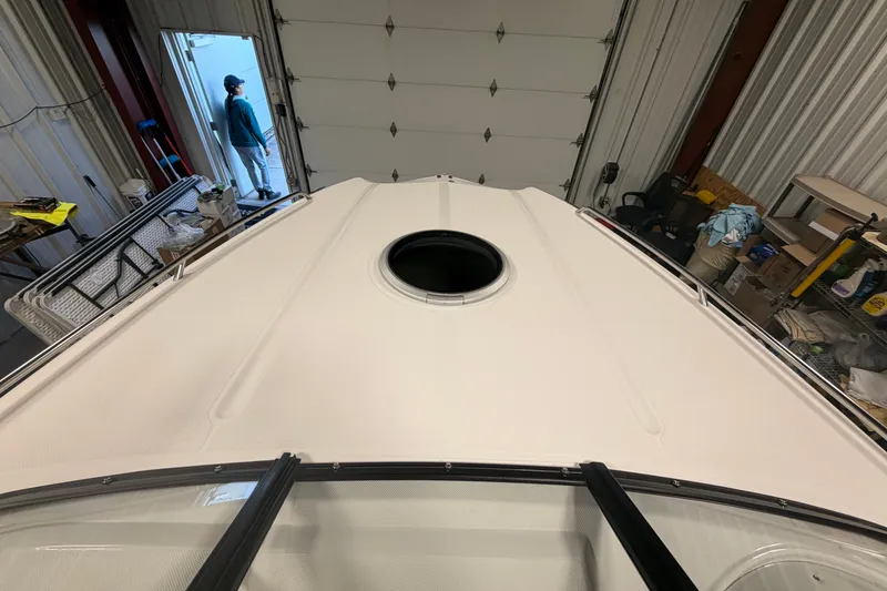 Slide: The Image of 2018 Rinker MTX 22 CC boat in a garage, viewed from above. - 13