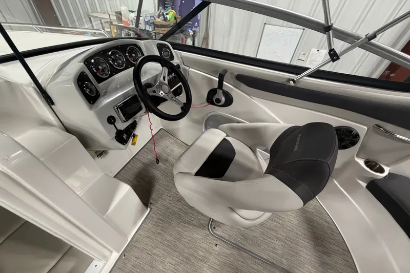 Slide: The Image of 2018 Rinker MTX 22 CC boat interior with steering wheel and dashboard controls. - 10