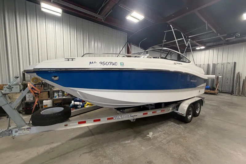 Slide: The Image of 2018 Rinker MTX 22 CC boat on trailer in indoor storage facility. - 1