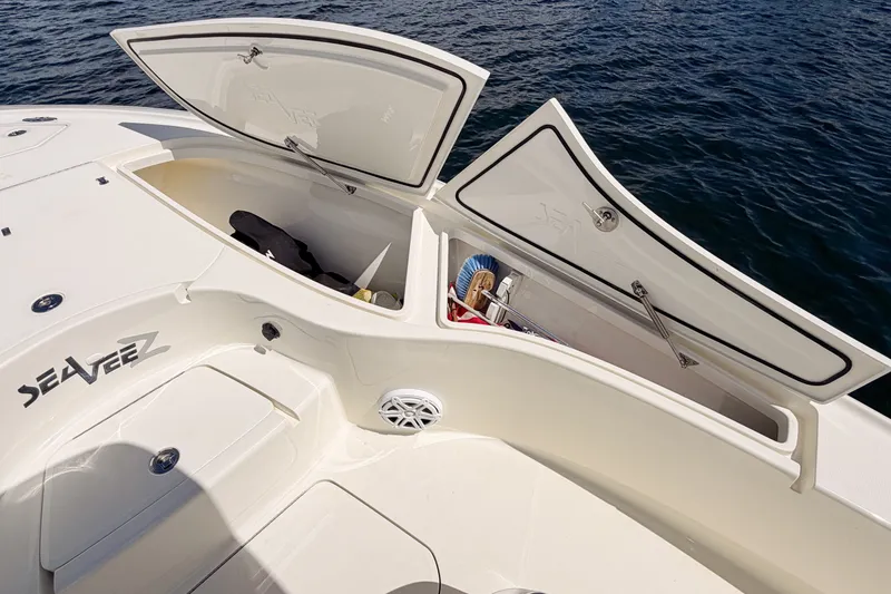 Slide: The Image of 2016 SeaVee 270Z boat storage compartments open on calm water. - 25