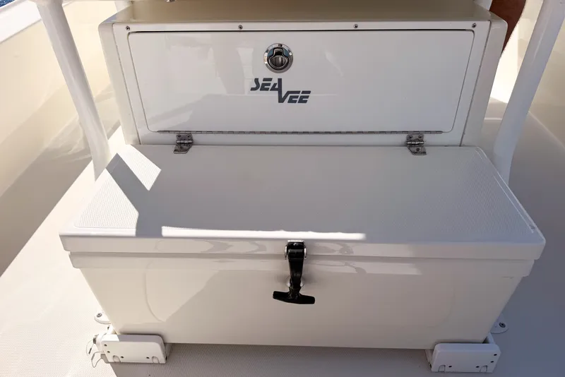 Slide: The Image of 2016 SeaVee 270Z boat storage compartment with secure latch and SeaVee logo. - 36