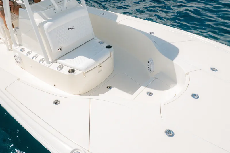 Slide: The Image of 2016 SeaVee 270Z boat deck with seating, surrounded by clear blue water. - 17