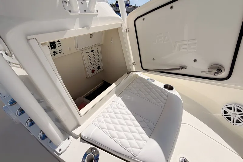 Slide: The Image of 2016 SeaVee 270Z boat interior with storage compartment and cushioned seating. - 28
