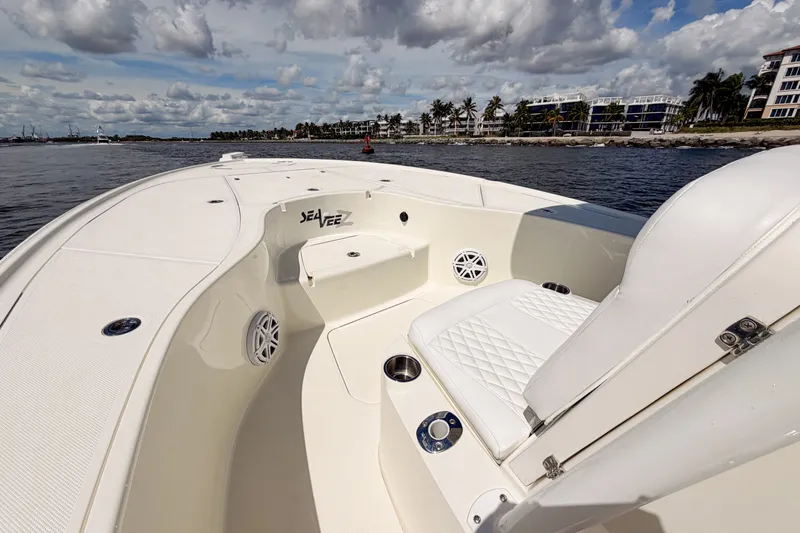 Slide: The Image of 2016 SeaVee 270Z boat interior with white seating, on calm water under cloudy sky. - 21