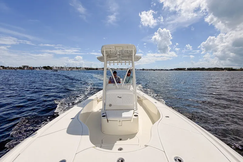 Slide: The Image of 2016 SeaVee 270Z boat cruising on open water under a clear blue sky. - 32