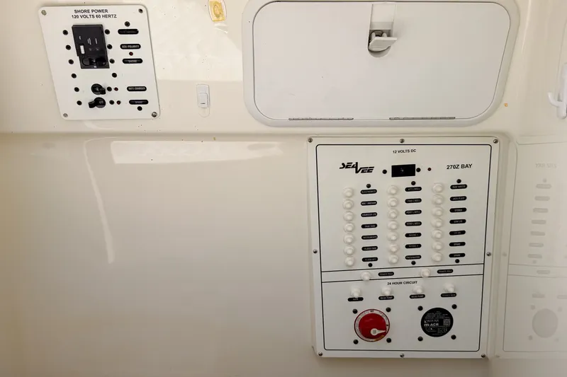 Slide: The Image of Electrical panel of a 2016 SeaVee 270Z boat, featuring shore power controls. - 29