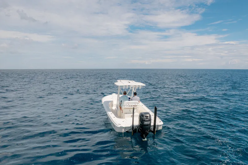 Slide: The Image of 2016 SeaVee 270Z boat cruising on open ocean under clear sky. - 13