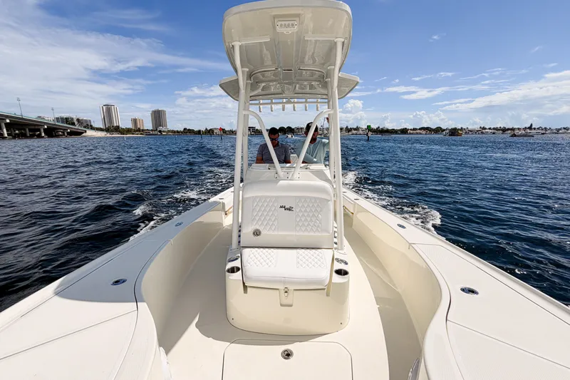 Slide: The Image of 2016 SeaVee 270Z boat cruising on open water under a clear blue sky. - 31