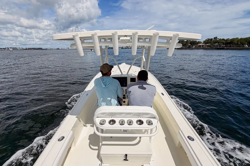 Slide: The Image of Two people navigating a 2016 SeaVee 270Z boat on open water. - 37