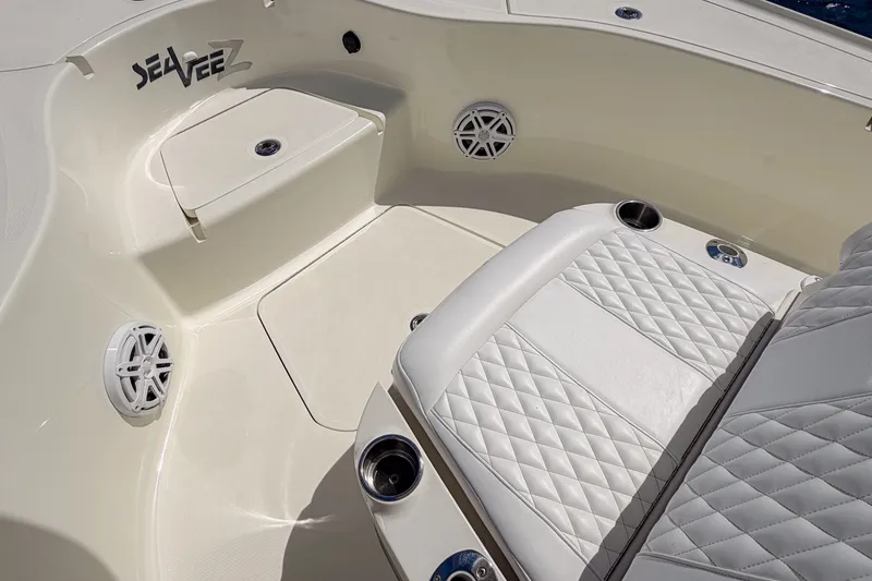 Slide: The Image of 2016 SeaVee 270Z boat interior with cushioned seating and cup holders. - 34
