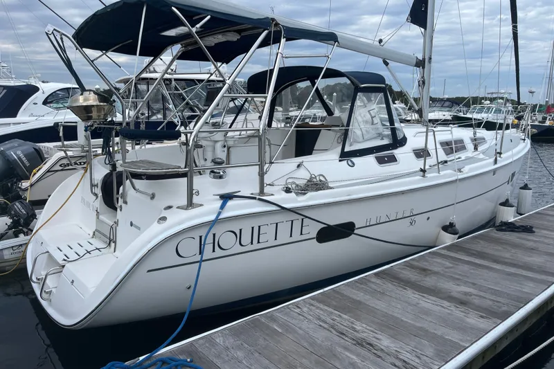 The Image of 2004 Hunter 36 sailboat named "Chouette" docked at a marina. - 0