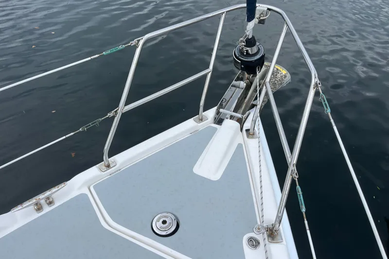 Slide: The Image of Bow of a 2004 Hunter 36 sailboat with anchor and railing over water. - 6