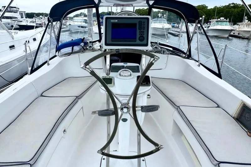 Slide: The Image of Cockpit of a 2004 Hunter 36 sailboat with navigation equipment and seating. - 2