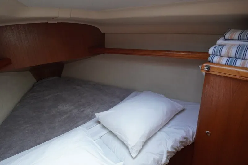Slide: The Image of Cozy cabin interior of 2004 Hunter 36 sailboat with neatly arranged bedding. - 9