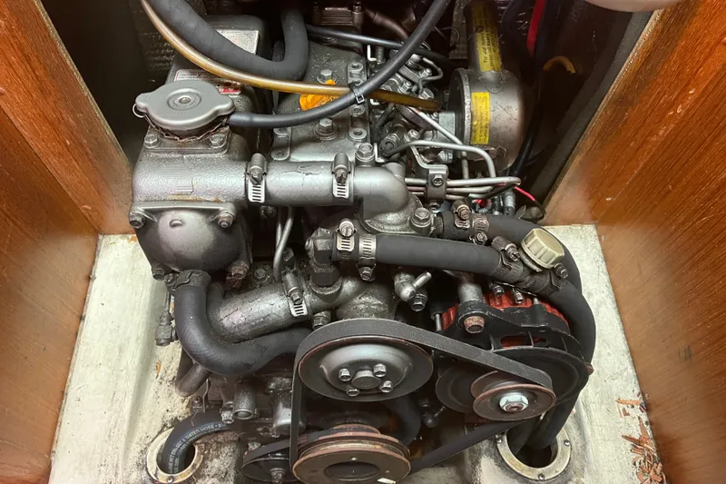 Slide: The Image of Engine compartment of a 2004 Hunter 36 sailboat, showcasing mechanical components and belts. - 16