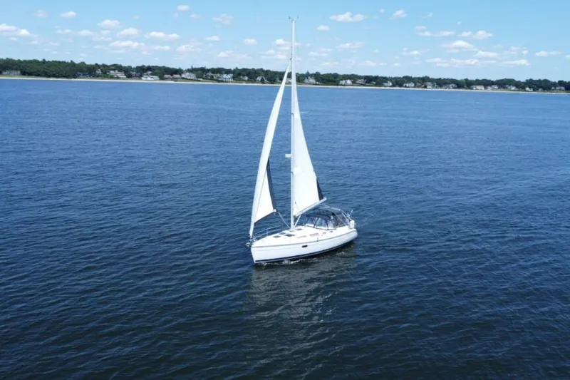 Slide: The Image of Sailboat on open water, 2004 Hunter 36 model, under clear blue sky. - 14
