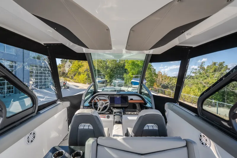 Slide: The Image of Interior view of 2027 Monterey Elite 27 OB boat, featuring modern dashboard and seating. - 61