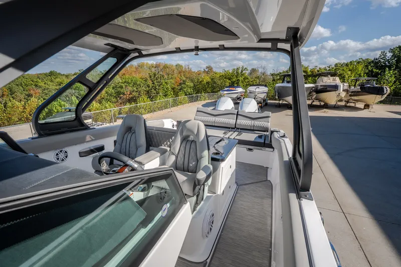 Slide: The Image of 2027 Monterey Elite 27 OB boat interior with modern seating and steering wheel. - 46
