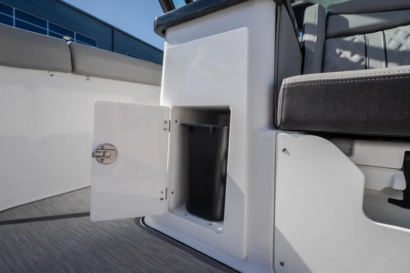 Slide: The Image of Storage compartment on a 2027 Monterey Elite 27 OB boat, featuring an open door and seating. - 52