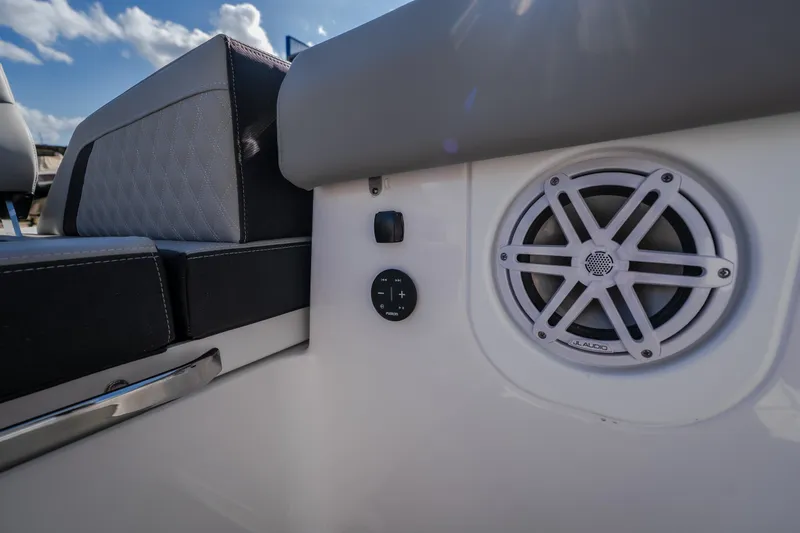 Slide: The Image of 2027 Monterey Elite 27 OB boat interior with JL Audio speaker and cushioned seating. - 51
