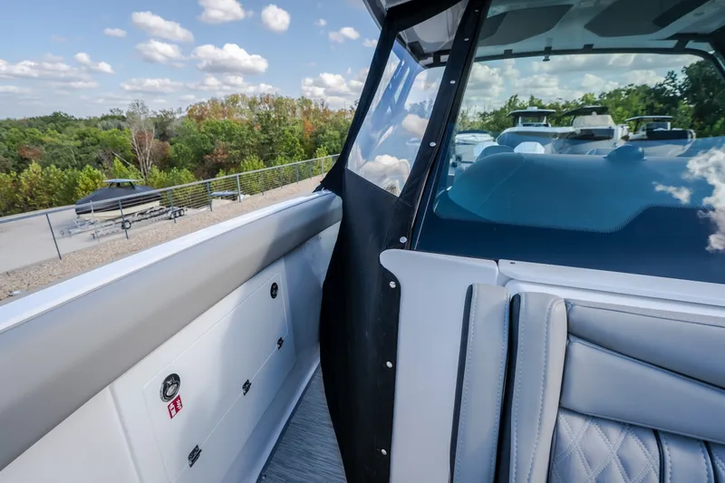 Slide: The Image of 2027 Monterey Elite 27 OB boat interior with sleek seating and modern design elements. - 59