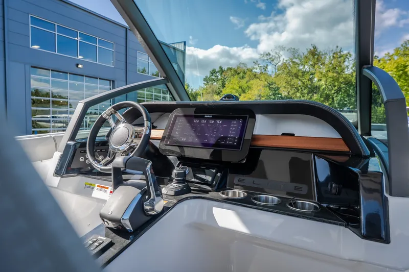 Slide: The Image of Cockpit of 2027 Monterey Elite 27 OB boat with modern steering and digital display. - 55