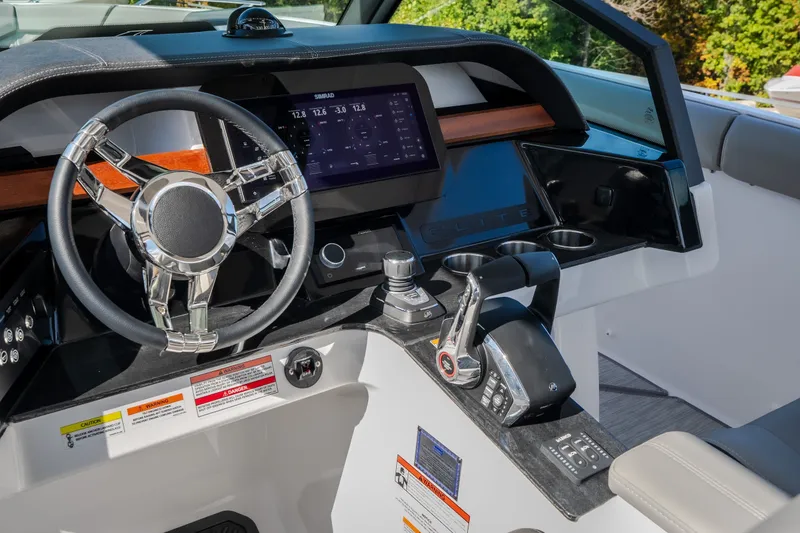 Slide: The Image of Cockpit of 2027 Monterey Elite 27 OB boat with modern steering and controls. - 25