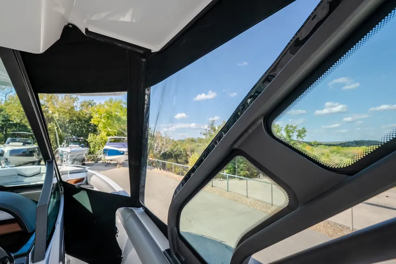 Slide: The Image of Interior view of 2027 Monterey Elite 27 OB boat with scenic outdoor background. - 63