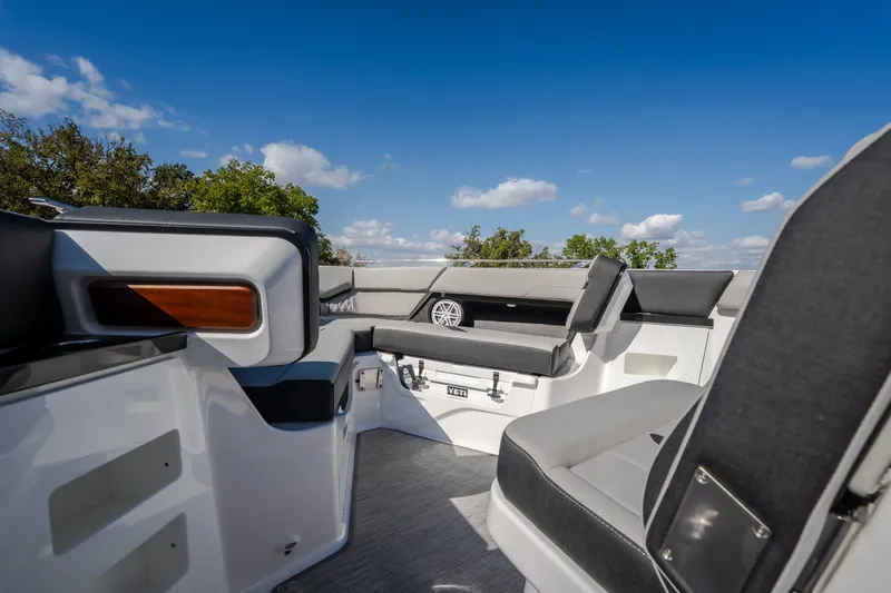 Slide: The Image of Luxurious seating on the 2027 Monterey Elite 27 OB boat under a clear blue sky. - 43