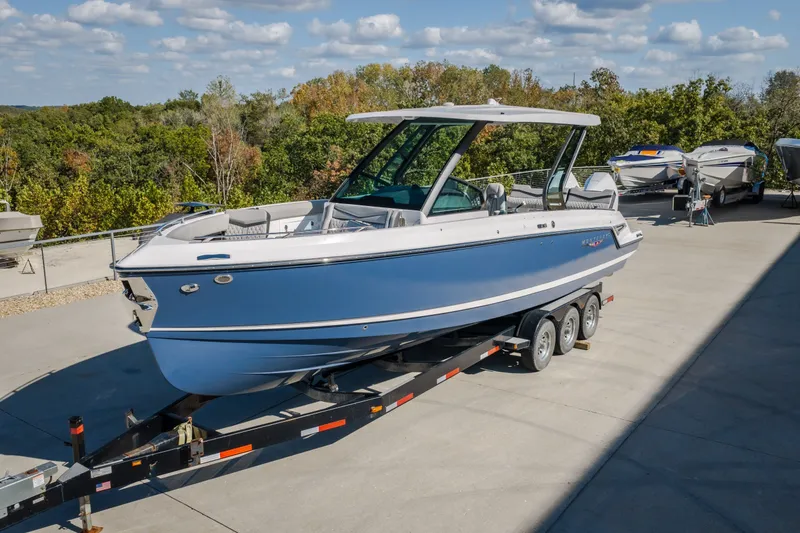 Slide: The Image of 2027 Monterey Elite 27 OB boat on trailer, parked outdoors under a clear sky. - 66