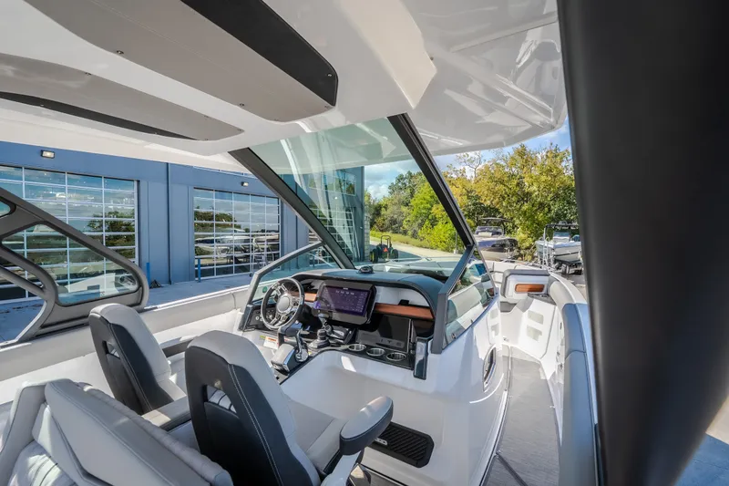 Slide: The Image of Interior view of 2027 Monterey Elite 27 OB boat with modern dashboard and seating. - 39