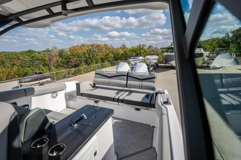Slide: The Image of 2027 Monterey Elite 27 OB boat interior with luxurious seating and scenic outdoor view. - 22