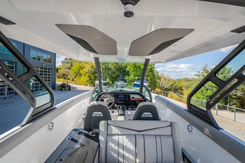 Slide: The Image of Interior view of 2027 Monterey Elite 27 OB boat, showcasing modern design and controls. - 18