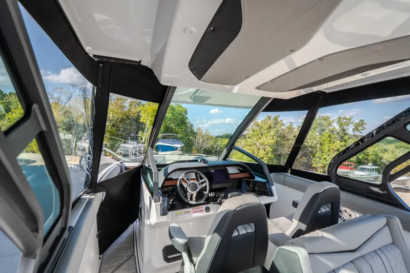 Slide: The Image of Interior view of 2027 Monterey Elite 27 OB boat, featuring modern dashboard and seating. - 60